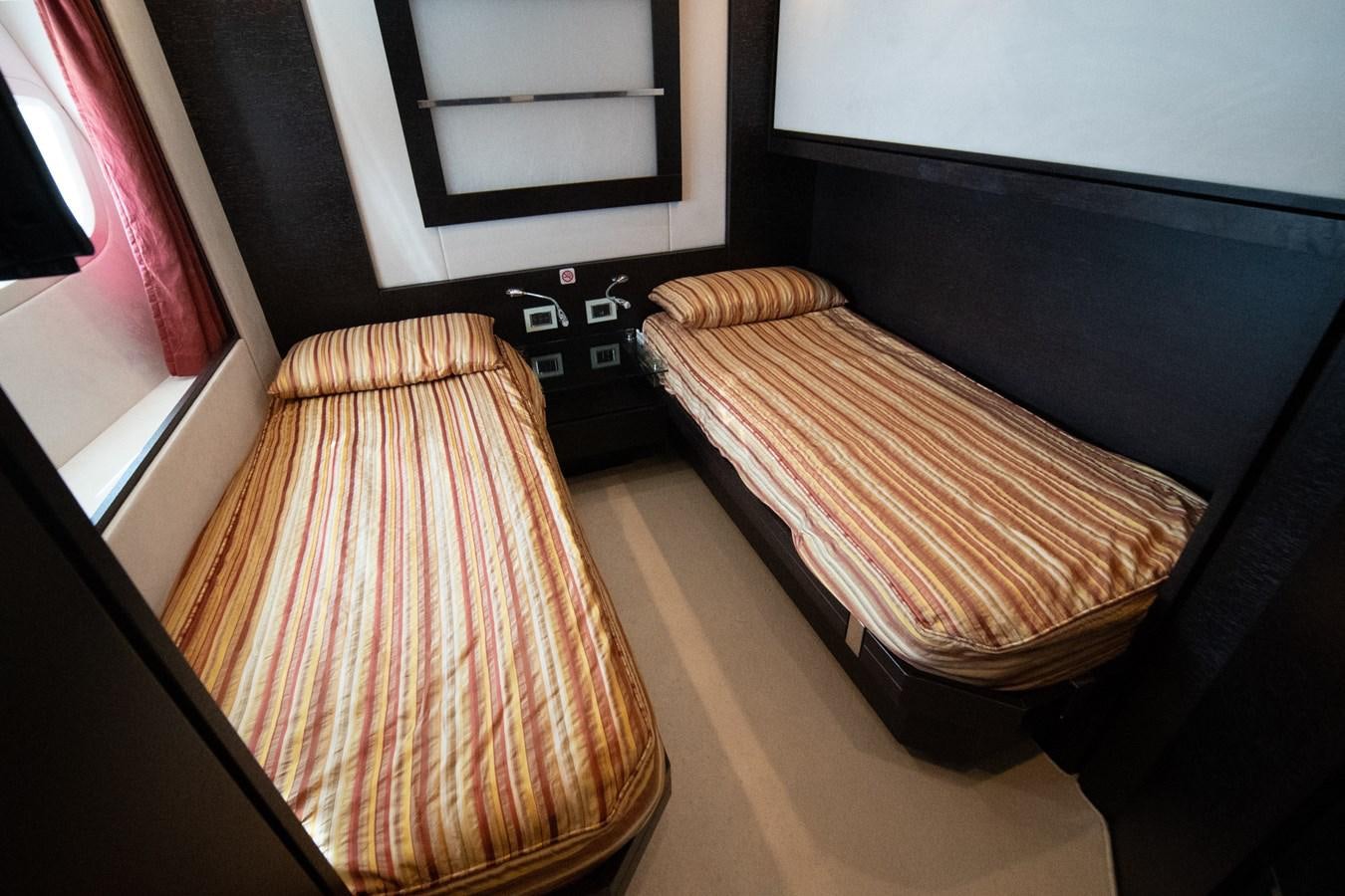 a room with a bed and a window aboard AQUARIUS Yacht for Sale