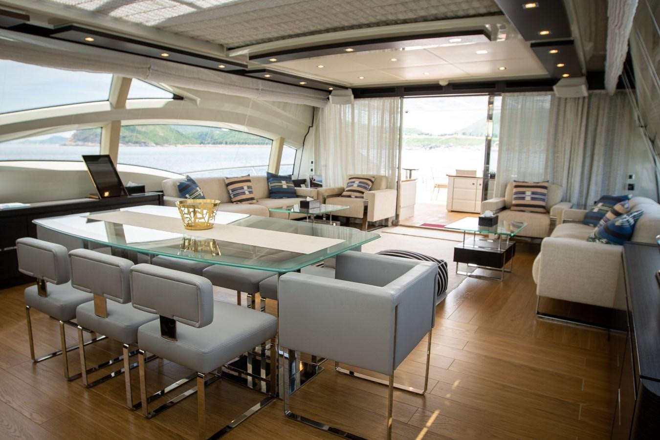 a large living room with a large table and chairs aboard AQUARIUS Yacht for Sale