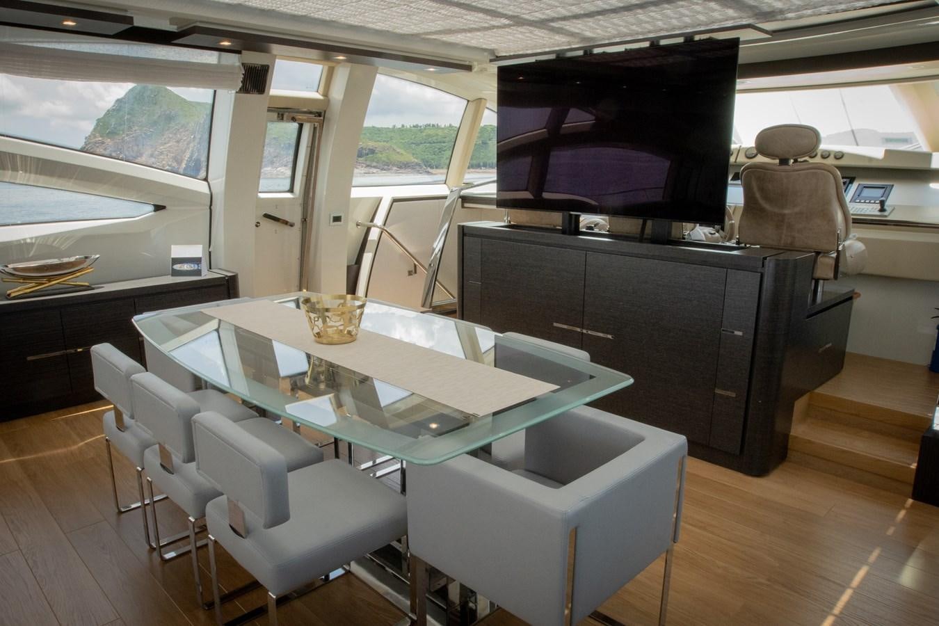 a room with a table and chairs aboard AQUARIUS Yacht for Sale
