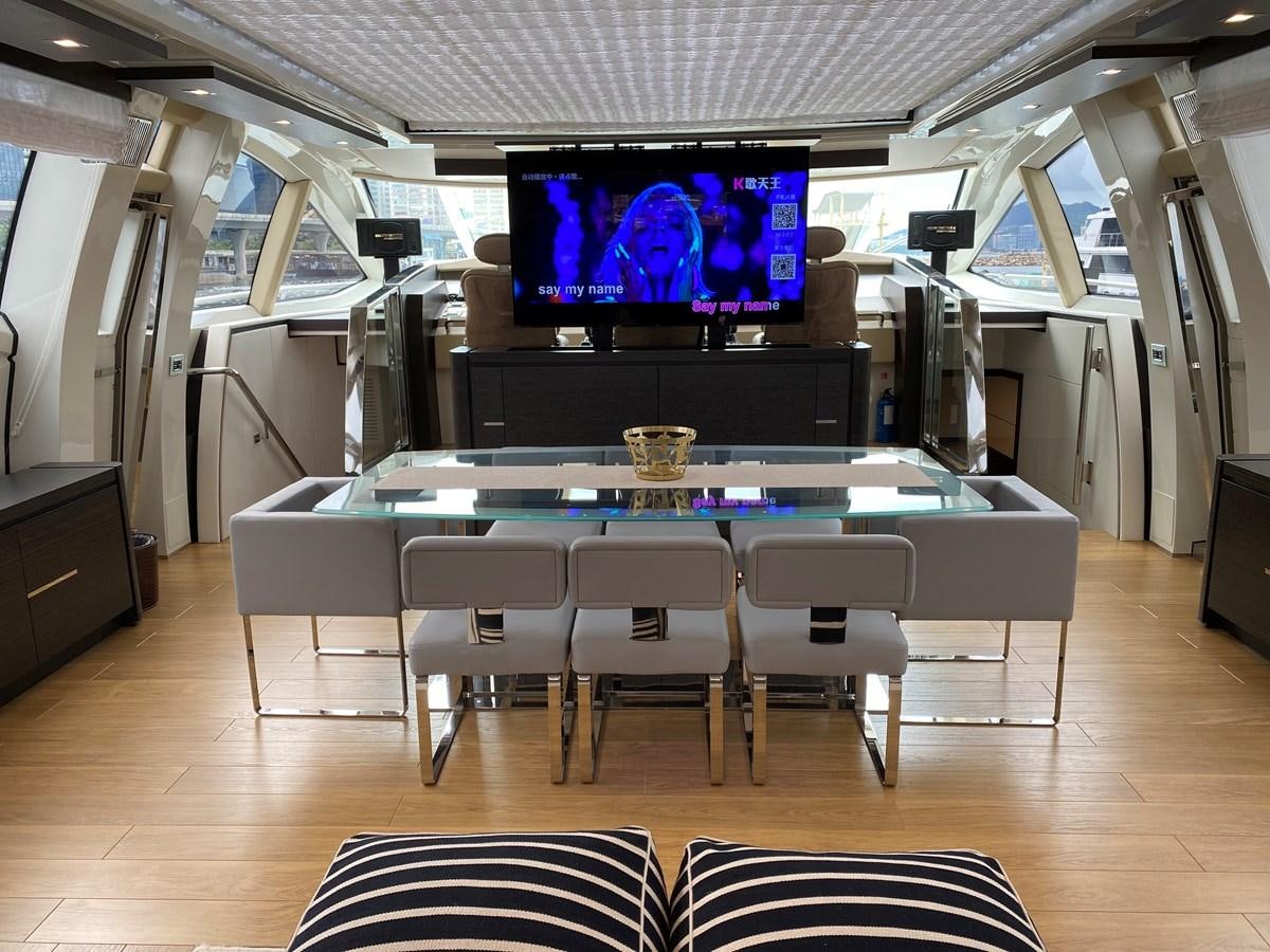 a room with a table and chairs aboard AQUARIUS Yacht for Sale