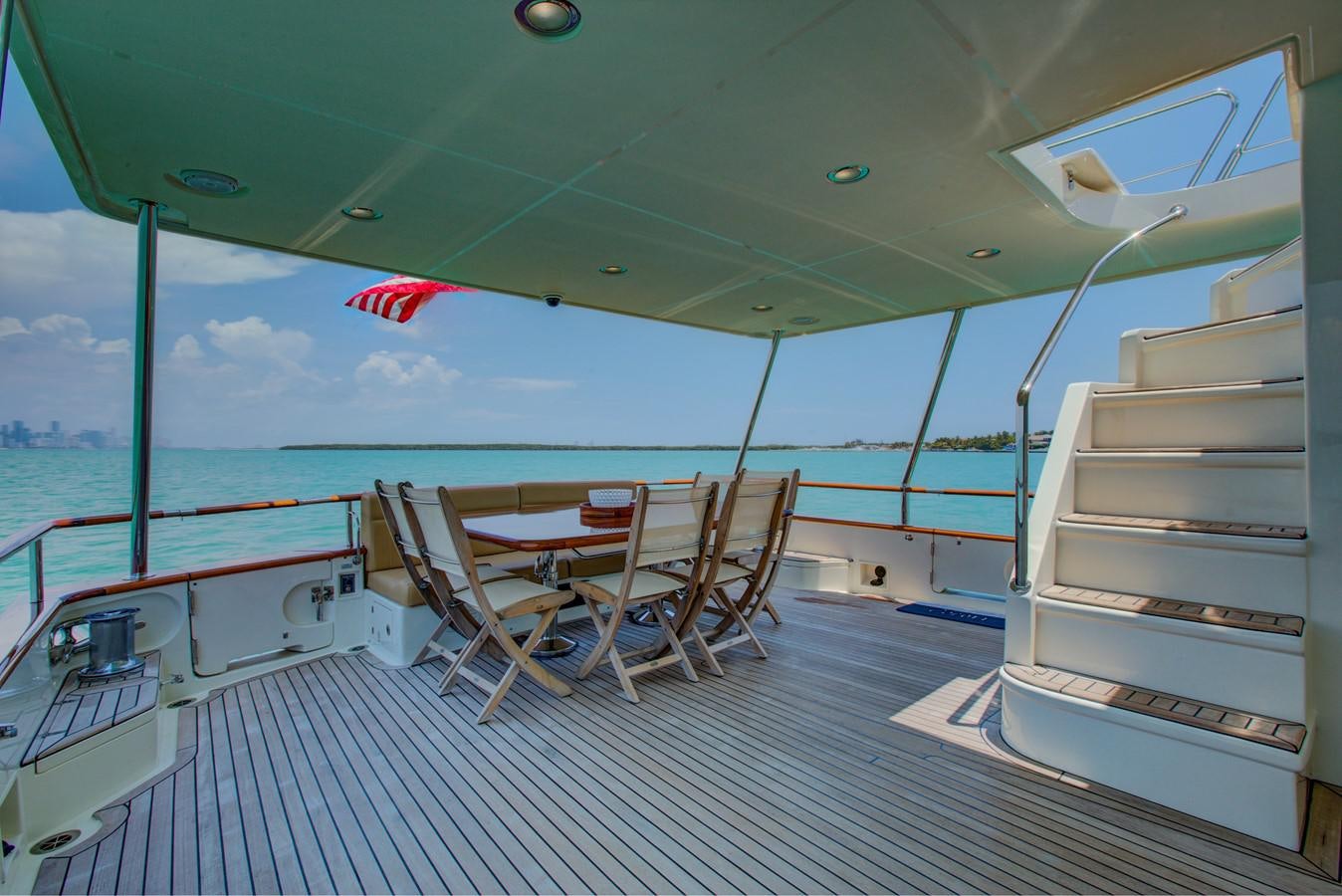 a boat with a deck and chairs on the deck aboard EXPLORER 97E-CB Yacht for Sale