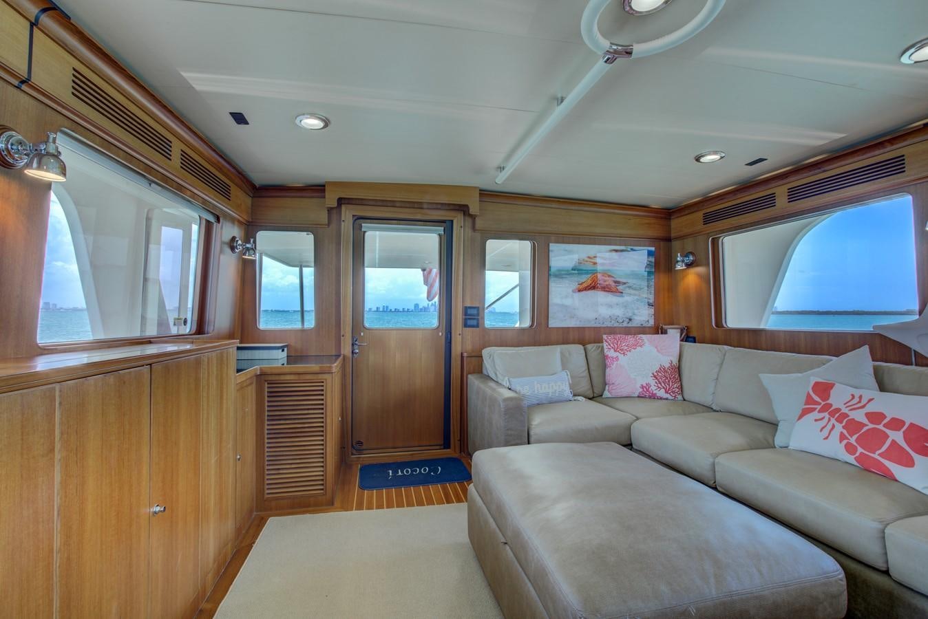 a living room with a couch and a window aboard EXPLORER 97E-CB Yacht for Sale