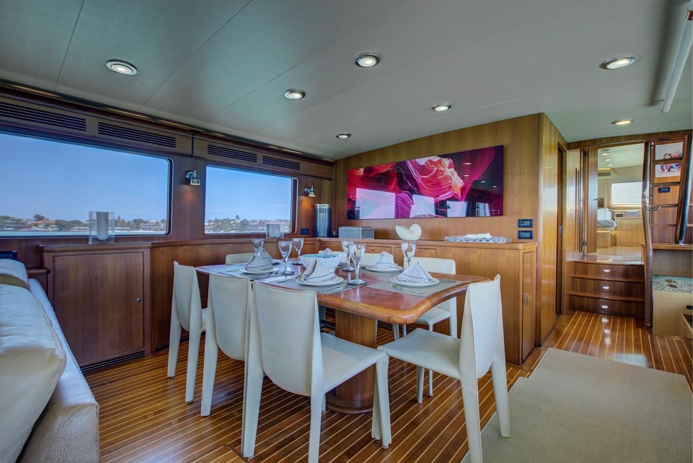 a dining room with a table and chairs aboard EXPLORER 97E-CB Yacht for Sale