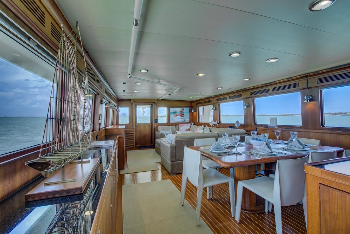 a large room with a table and chairs aboard EXPLORER 97E-CB Yacht for Sale