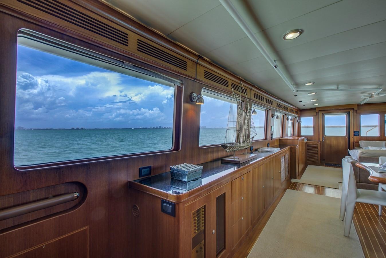 a room with a large window and a large blue ocean aboard EXPLORER 97E-CB Yacht for Sale