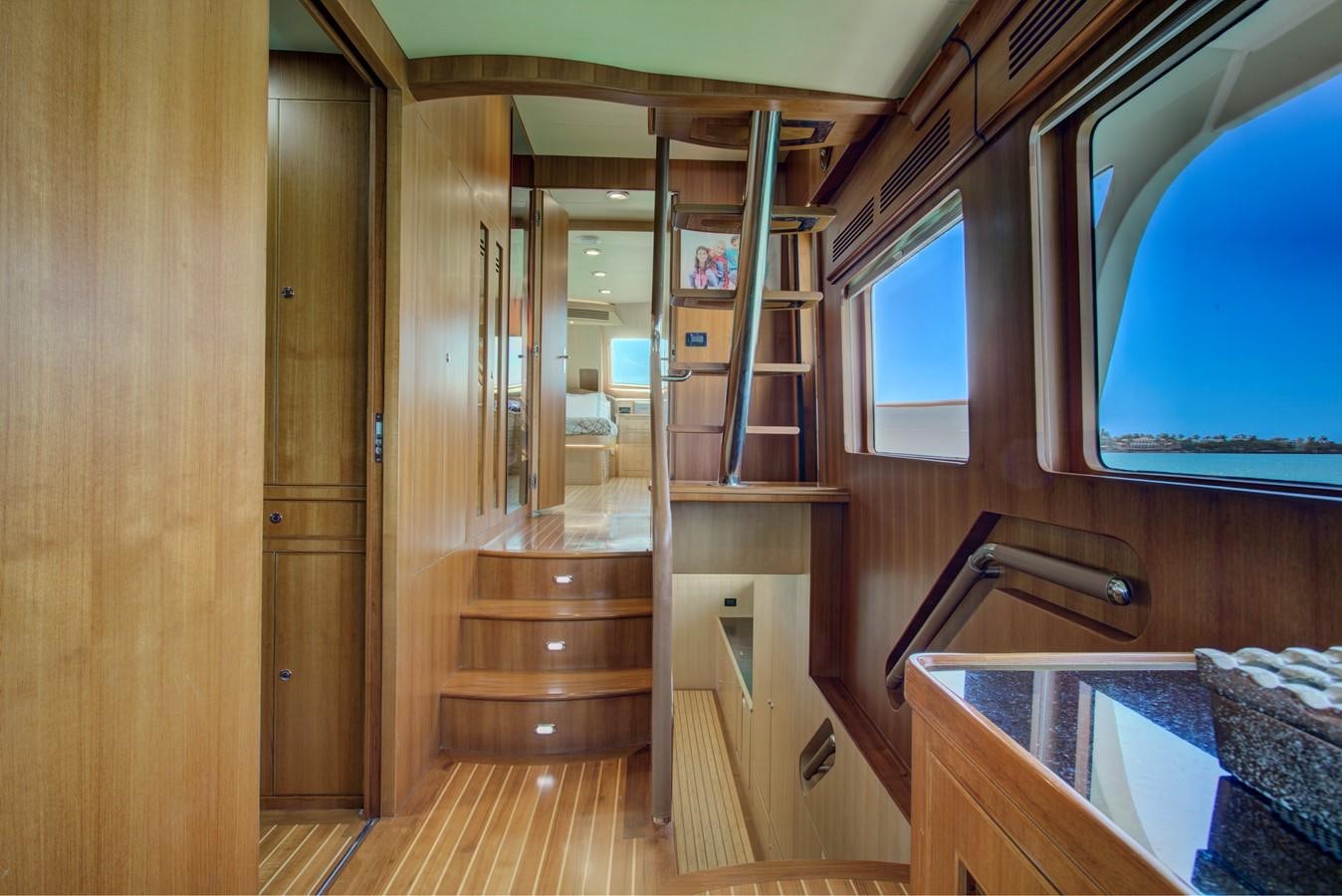 a wooden bunk bed in a room aboard EXPLORER 97E-CB Yacht for Sale