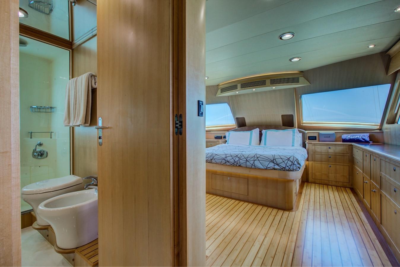 a bathroom with a bed and a sink aboard EXPLORER 97E-CB Yacht for Sale