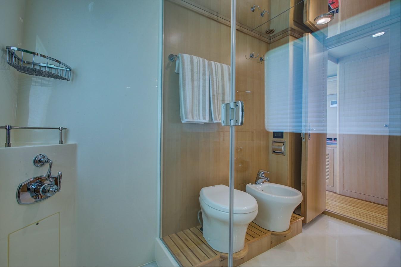 a bathroom with a toilet and sink aboard EXPLORER 97E-CB Yacht for Sale
