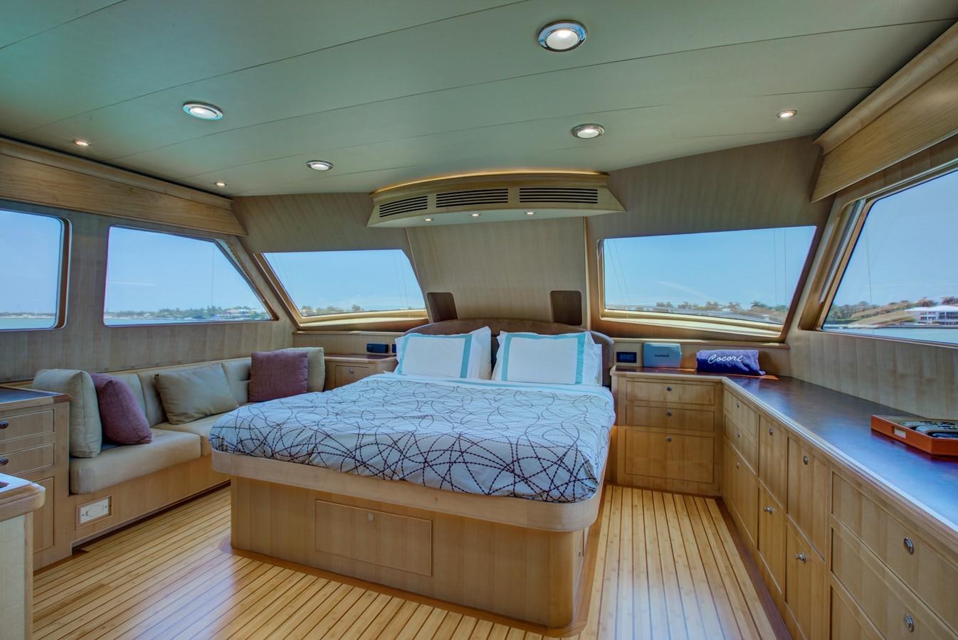 a bedroom with a bed and a couch aboard EXPLORER 97E-CB Yacht for Sale