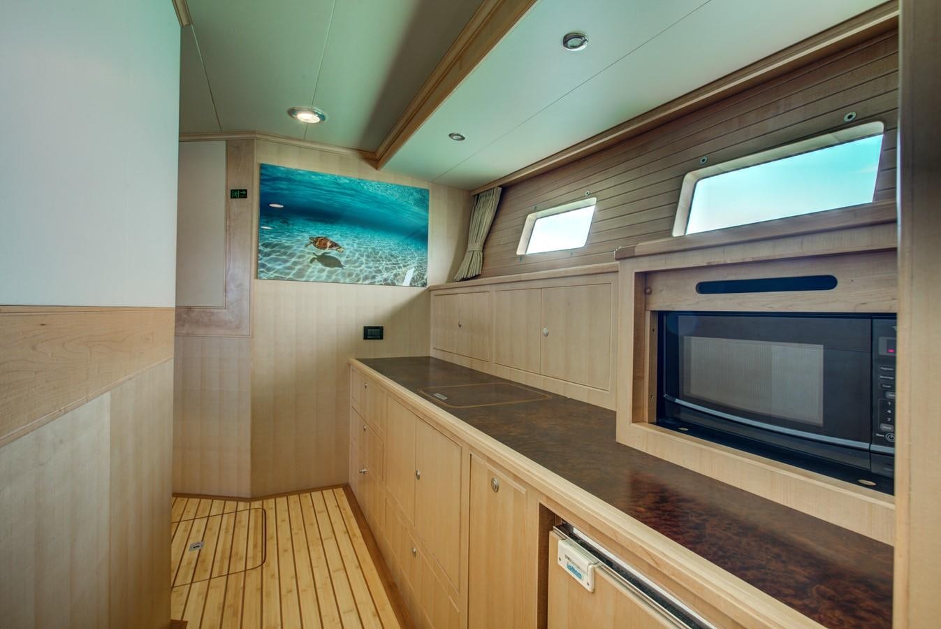 a kitchen with a microwave oven aboard EXPLORER 97E-CB Yacht for Sale