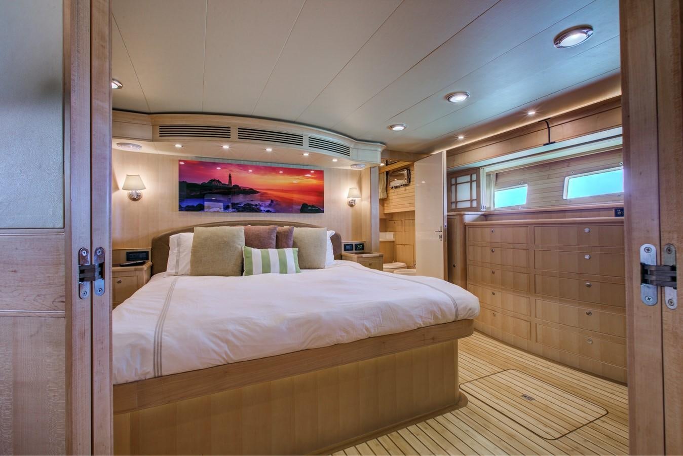 a bedroom with a bed aboard EXPLORER 97E-CB Yacht for Sale