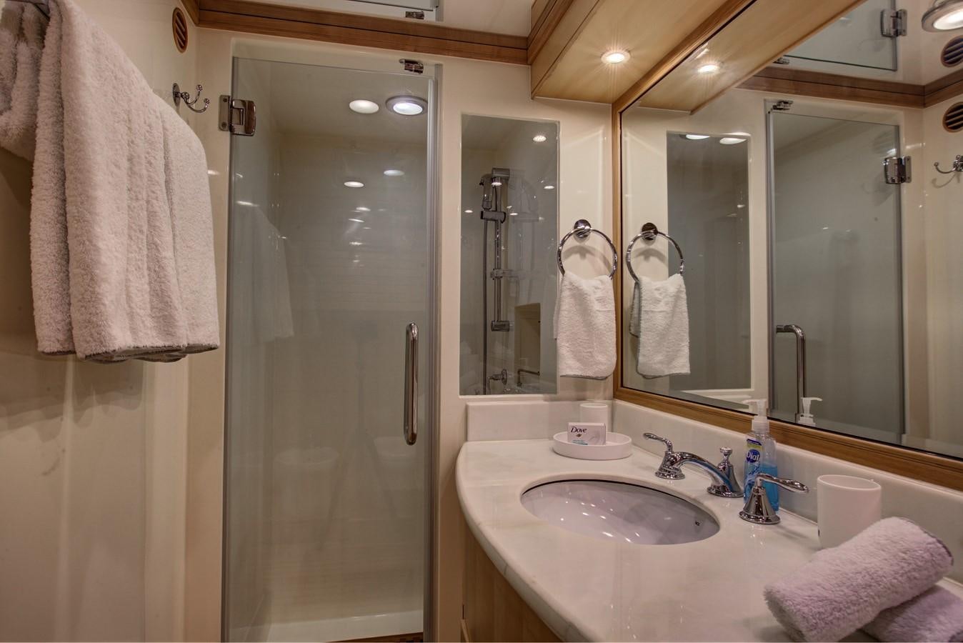 a bathroom with a sink and a shower aboard EXPLORER 97E-CB Yacht for Sale