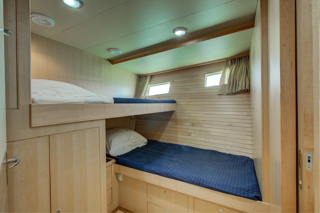 a room with a bed and a window aboard EXPLORER 97E-CB Yacht for Sale