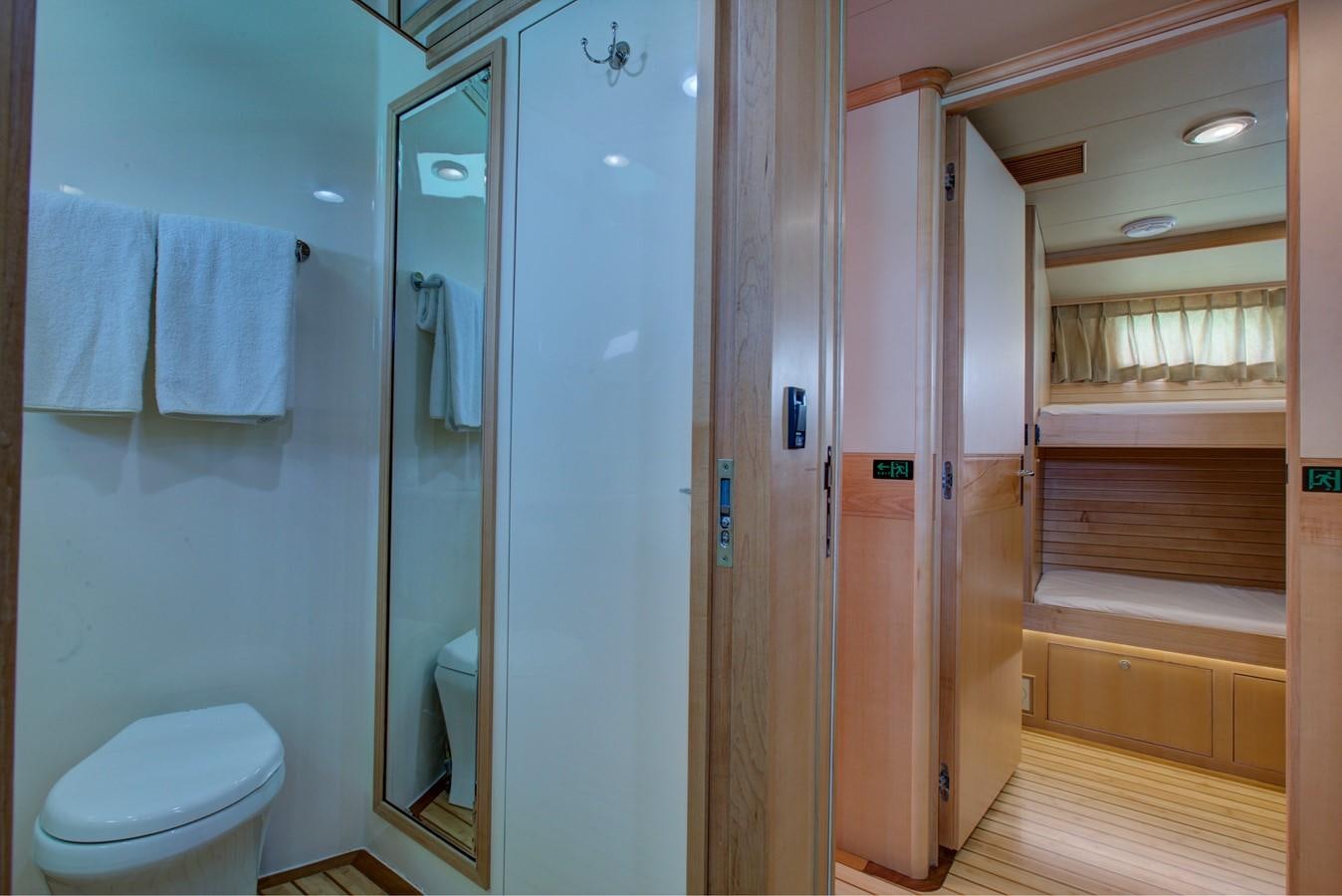a bathroom with a toilet and a shower unit aboard EXPLORER 97E-CB Yacht for Sale