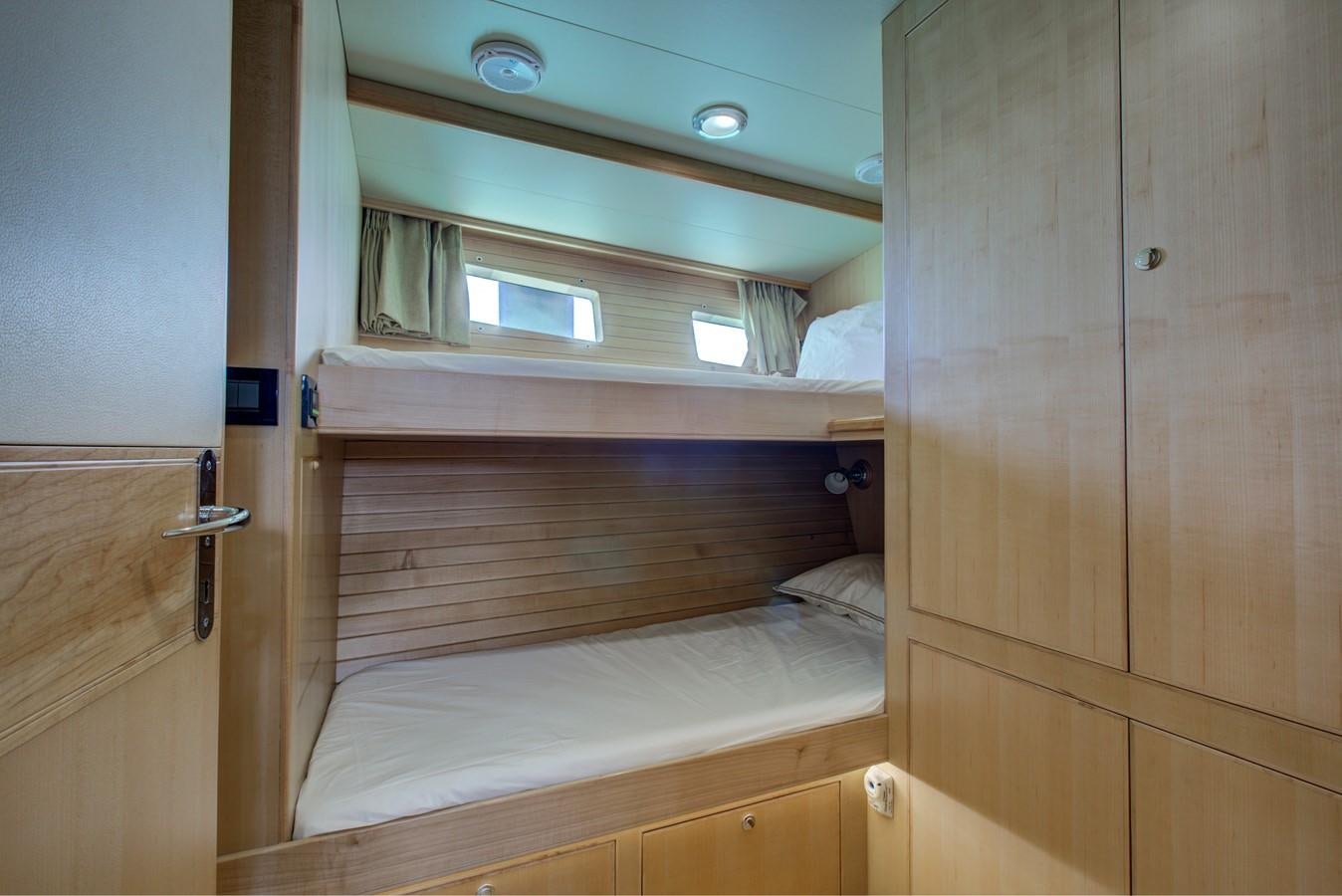 a room with a closet and a bed aboard EXPLORER 97E-CB Yacht for Sale