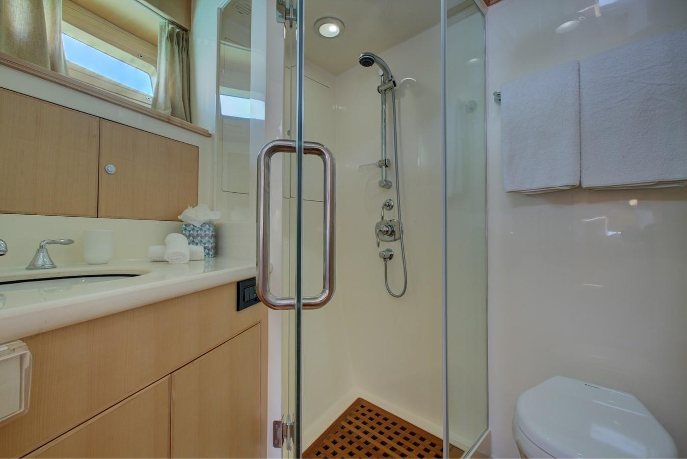 a bathroom with a shower and toilet aboard EXPLORER 97E-CB Yacht for Sale