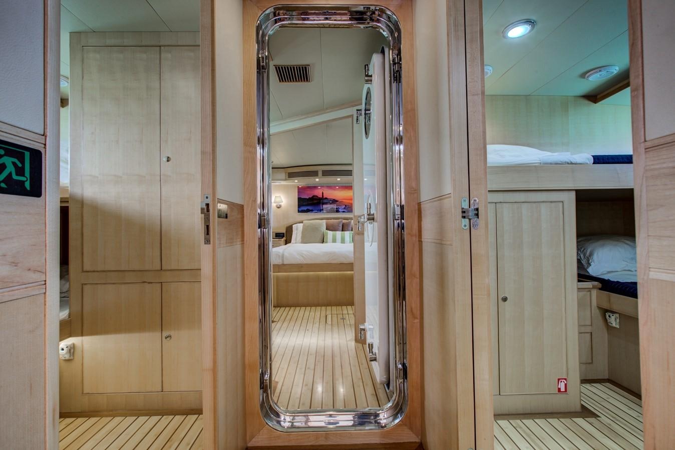 a room with a closet and a bed aboard EXPLORER 97E-CB Yacht for Sale