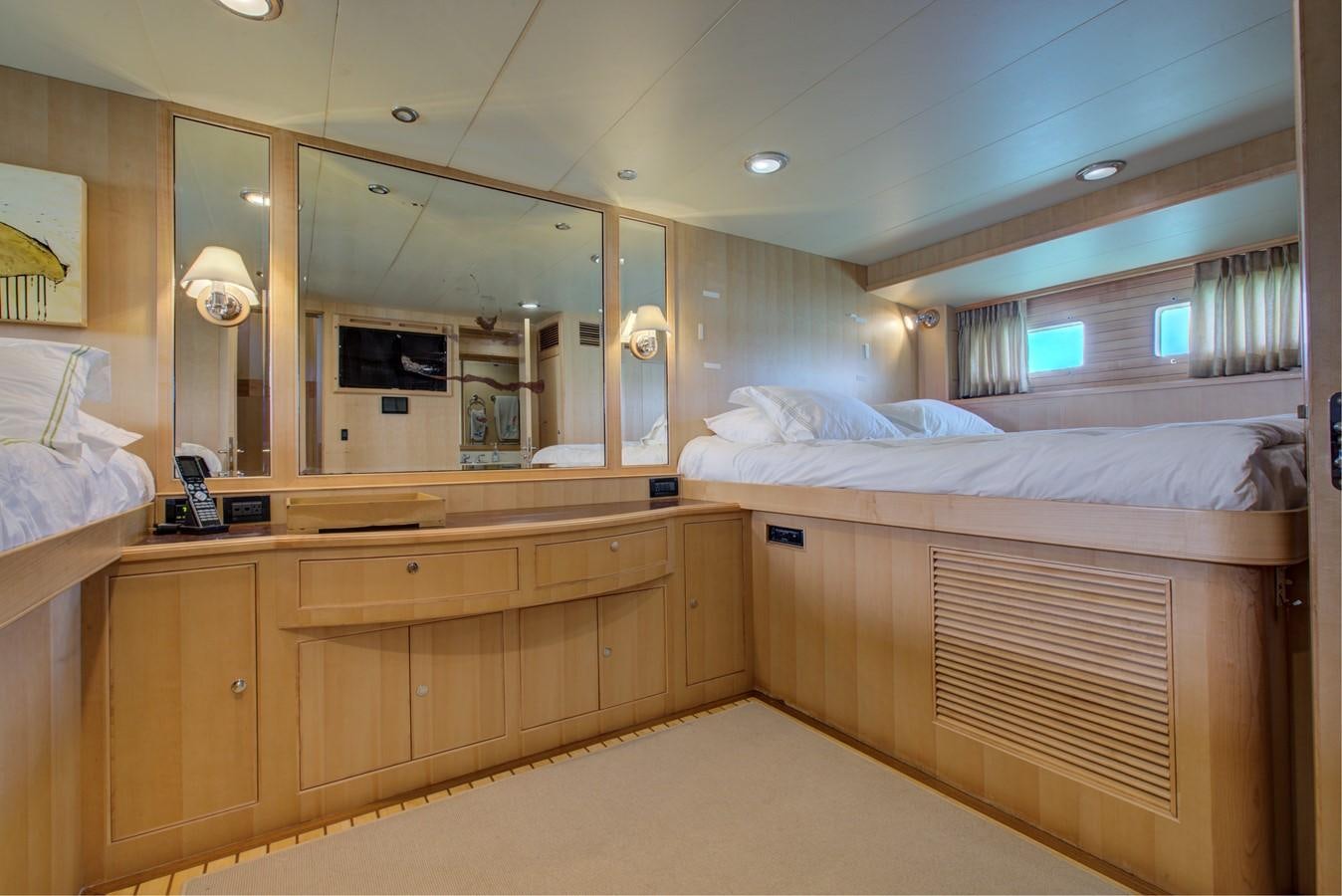 a room with a bed and a mirror aboard EXPLORER 97E-CB Yacht for Sale