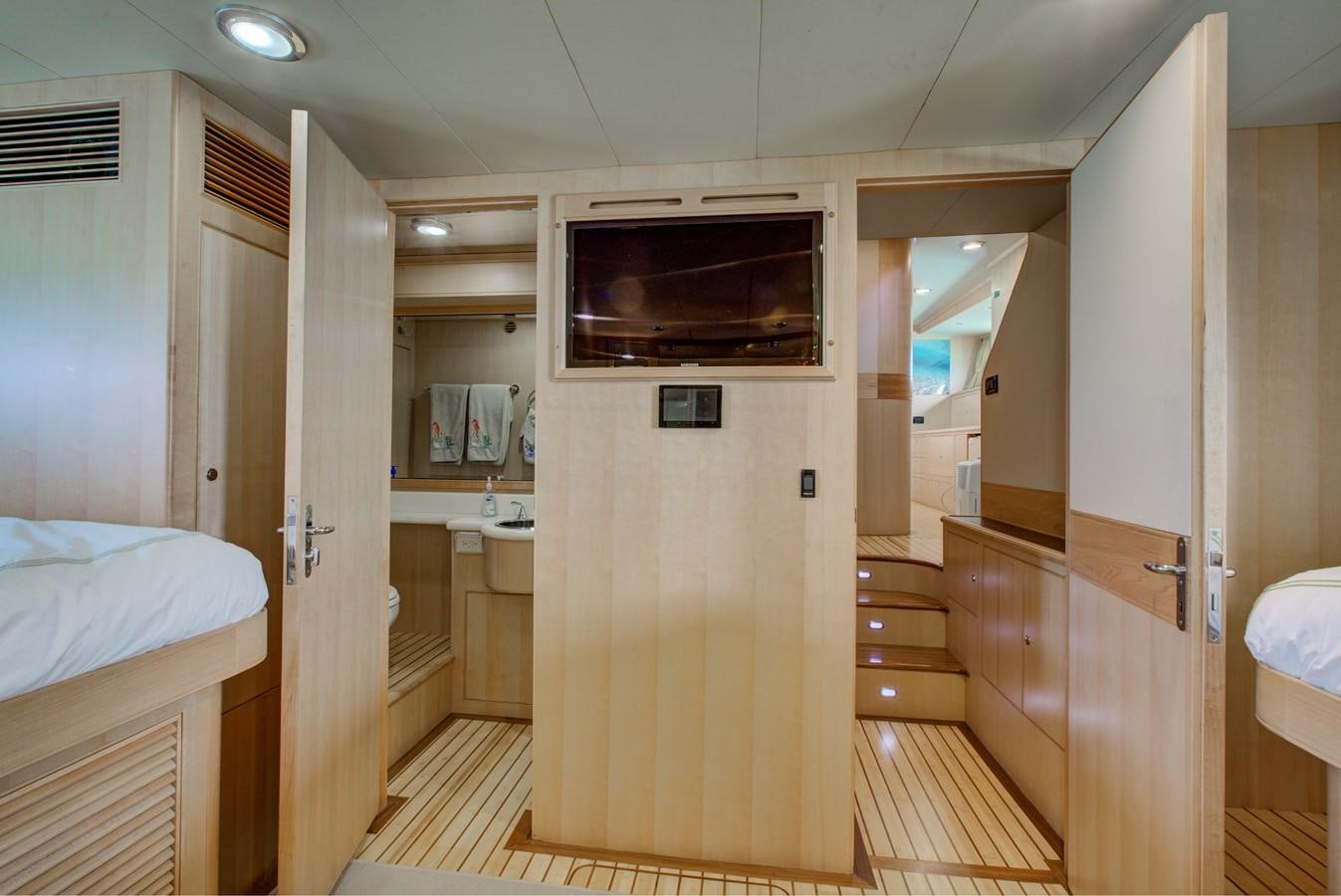 a room with a bed and a television aboard EXPLORER 97E-CB Yacht for Sale
