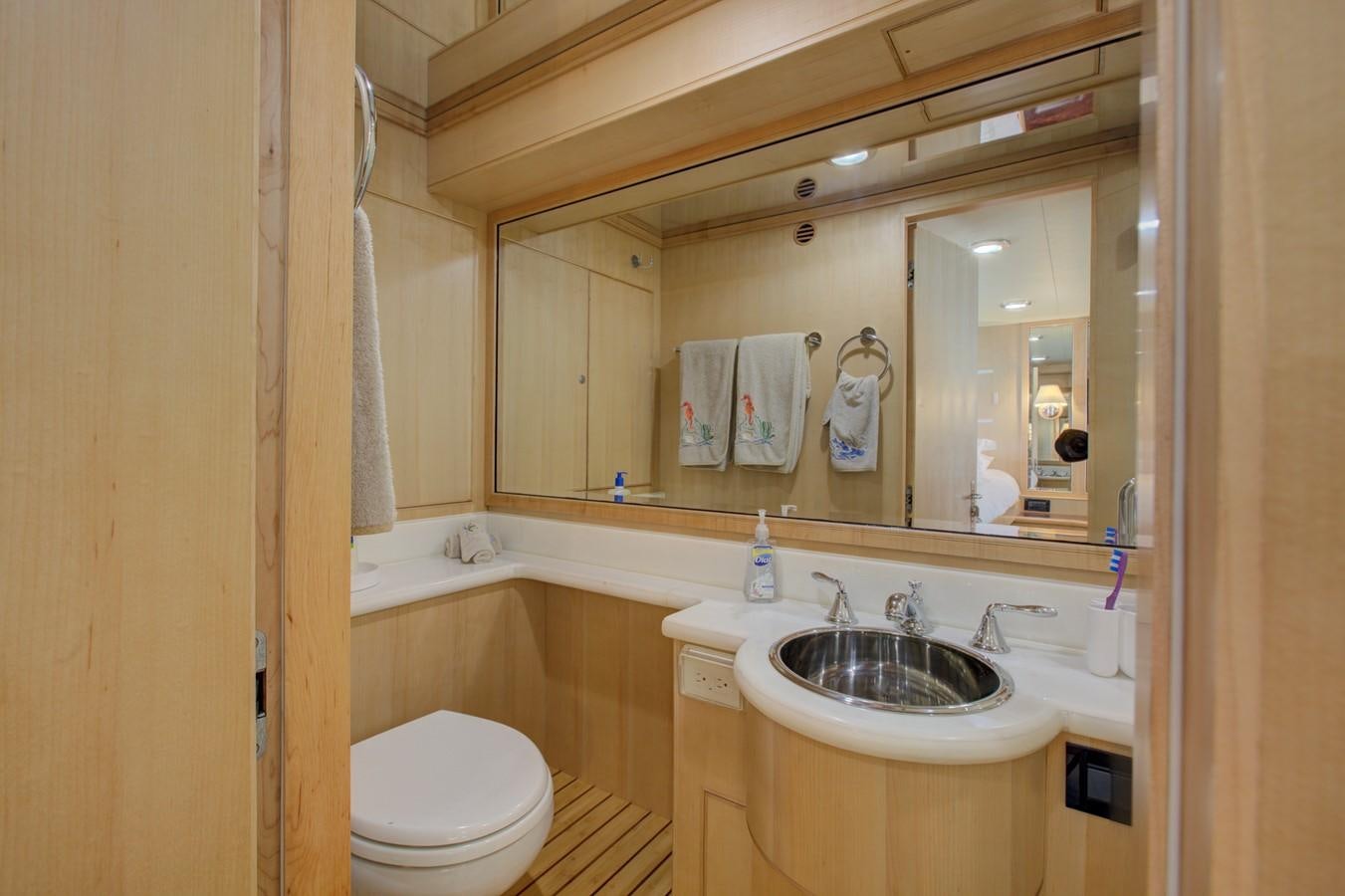 a bathroom with a large mirror aboard EXPLORER 97E-CB Yacht for Sale