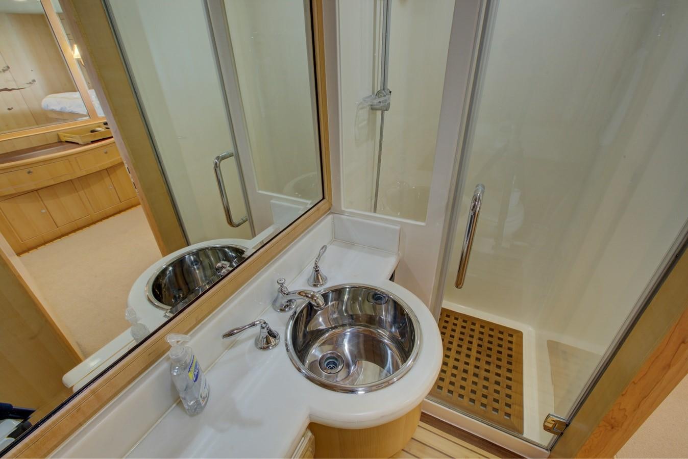 a bathroom with a sink and a mirror aboard EXPLORER 97E-CB Yacht for Sale