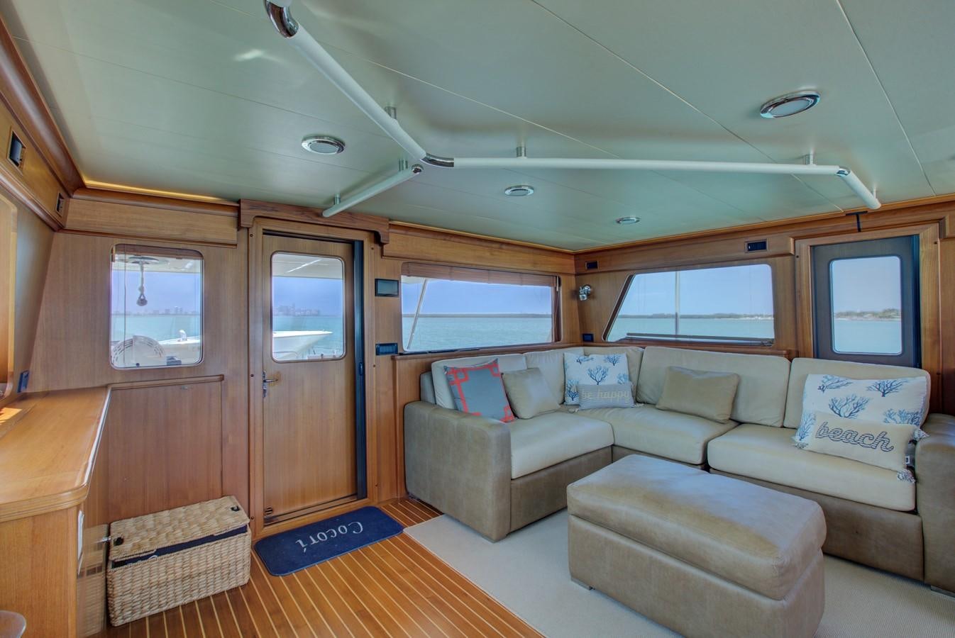 a living room with a couch and a window aboard EXPLORER 97E-CB Yacht for Sale