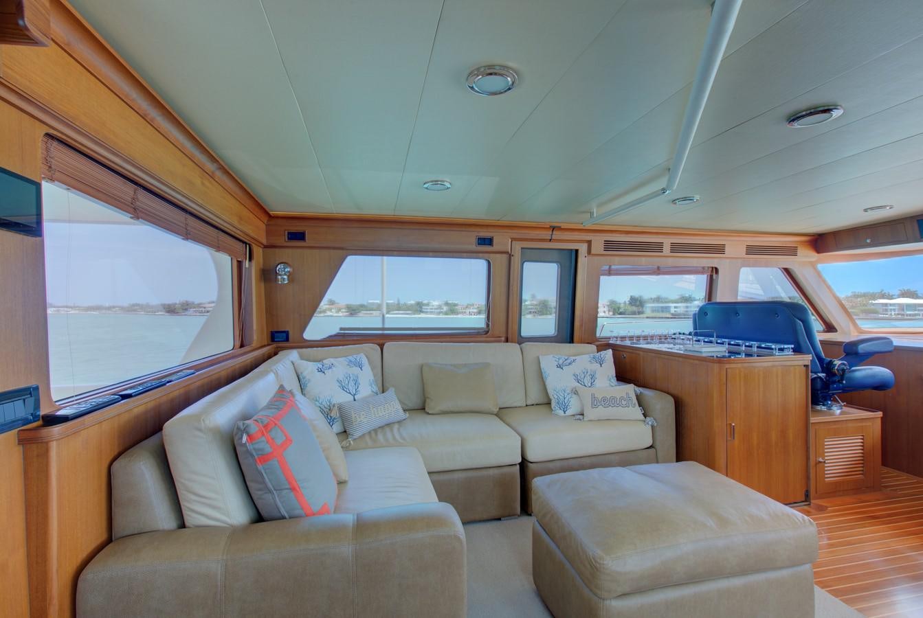 a train with a couch and a table aboard EXPLORER 97E-CB Yacht for Sale