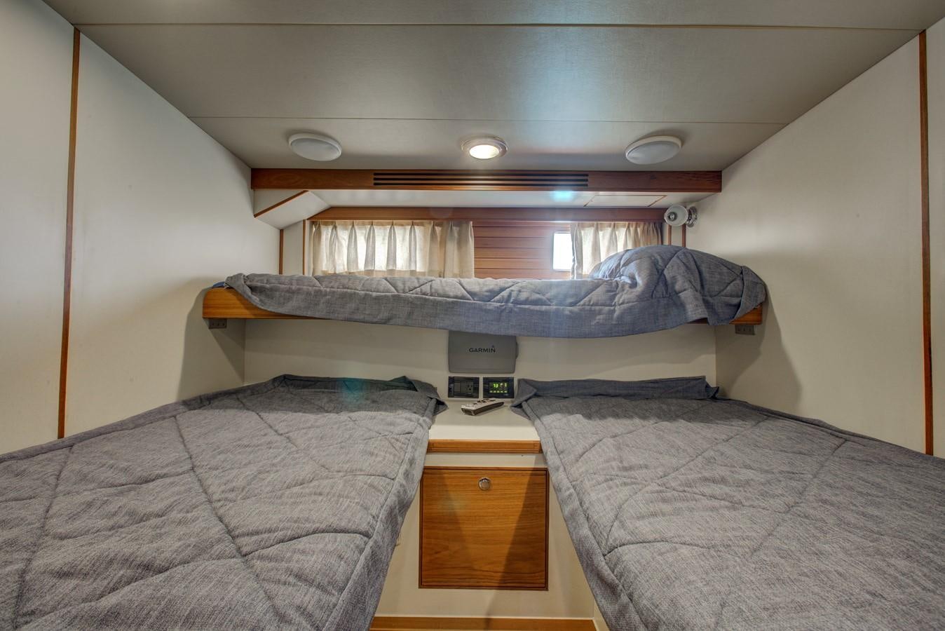 a couple of beds in a room aboard EXPLORER 97E-CB Yacht for Sale