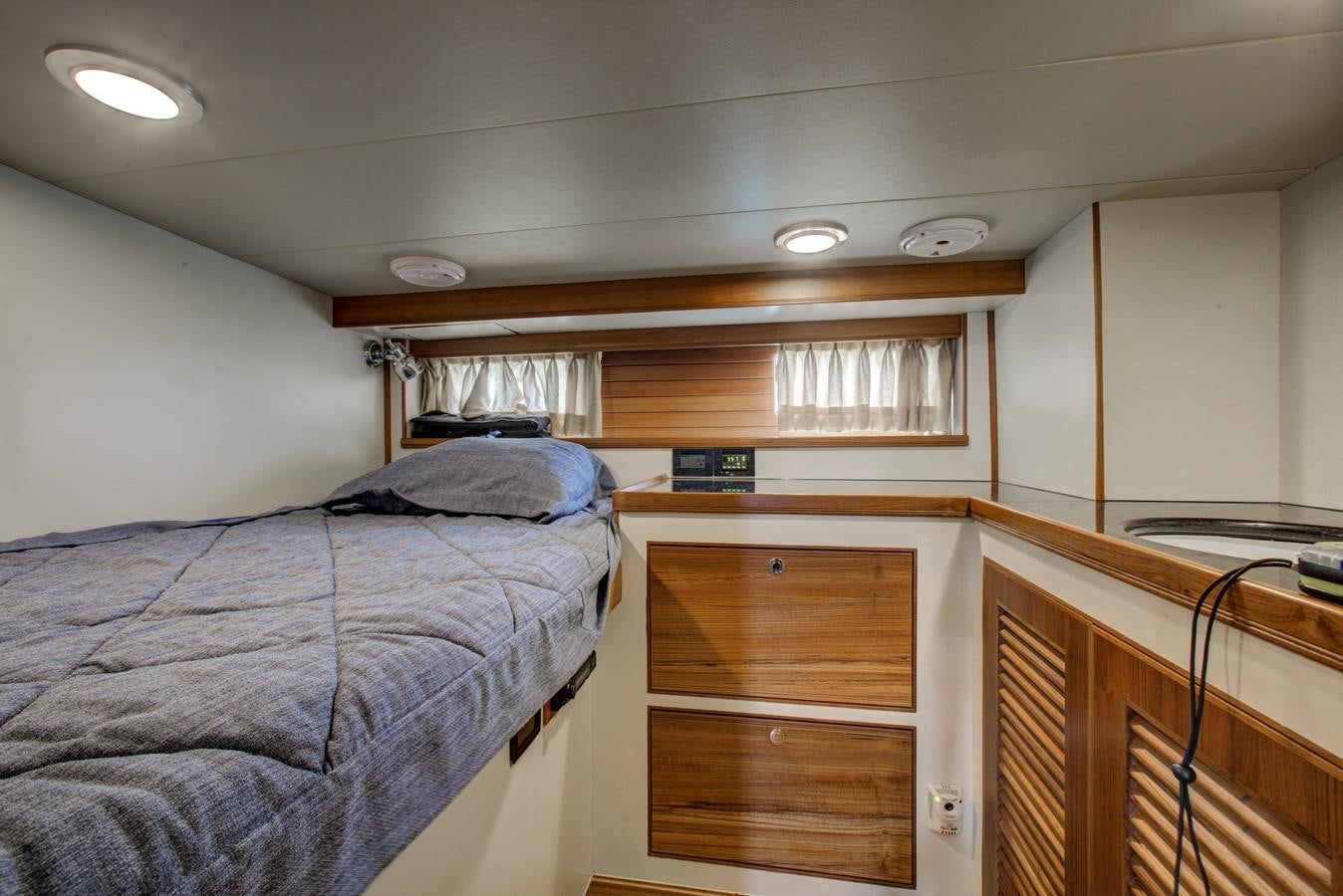 a bedroom with a bunk bed aboard EXPLORER 97E-CB Yacht for Sale