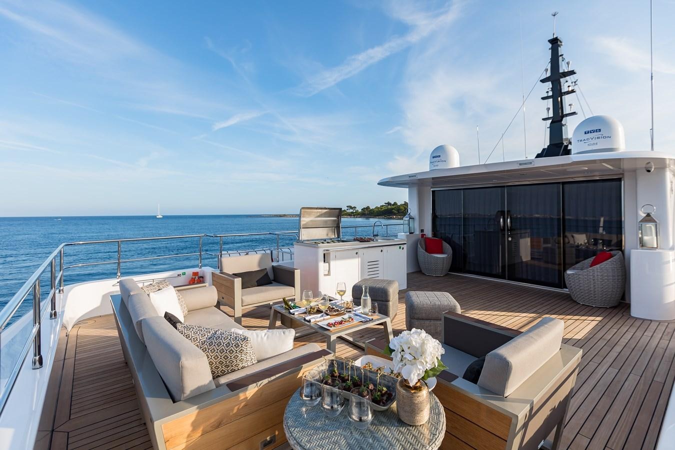 a deck with a large body of water and a large ship in the background aboard JEWEL Yacht for Sale