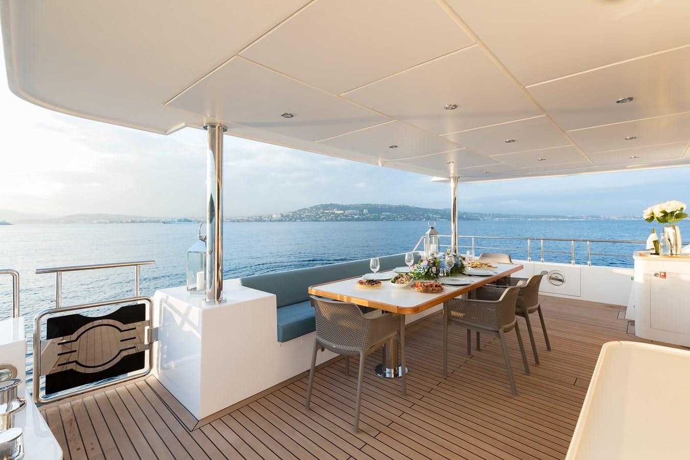 a table and chairs on a boat aboard JEWEL Yacht for Sale