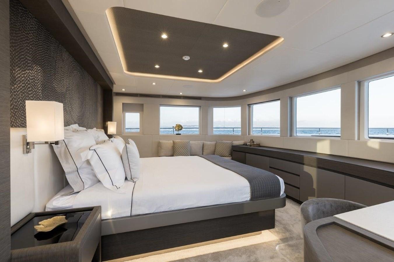 a bedroom with a bed and a large window aboard JEWEL Yacht for Sale