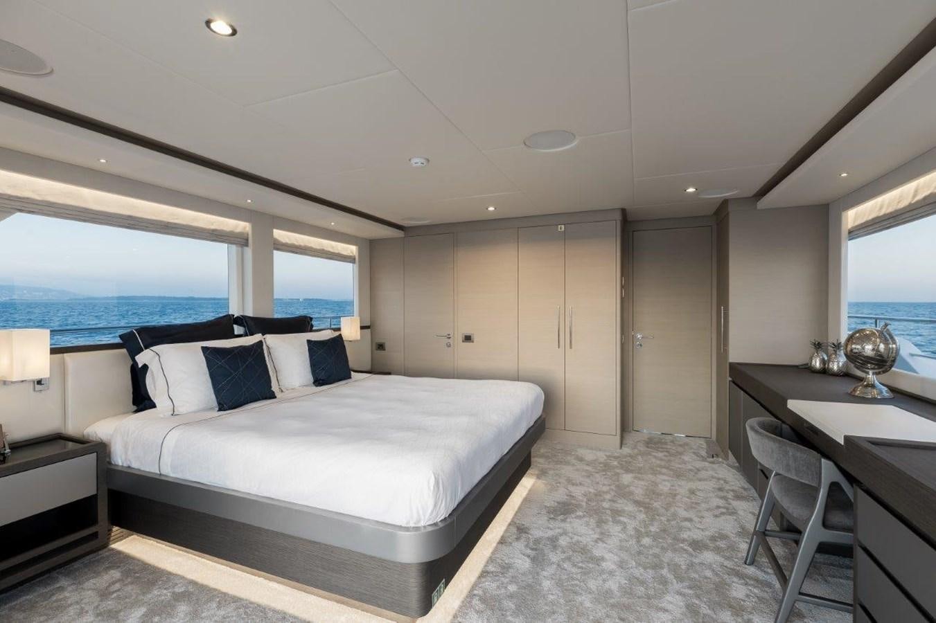 a large bedroom with a large bed aboard JEWEL Yacht for Sale