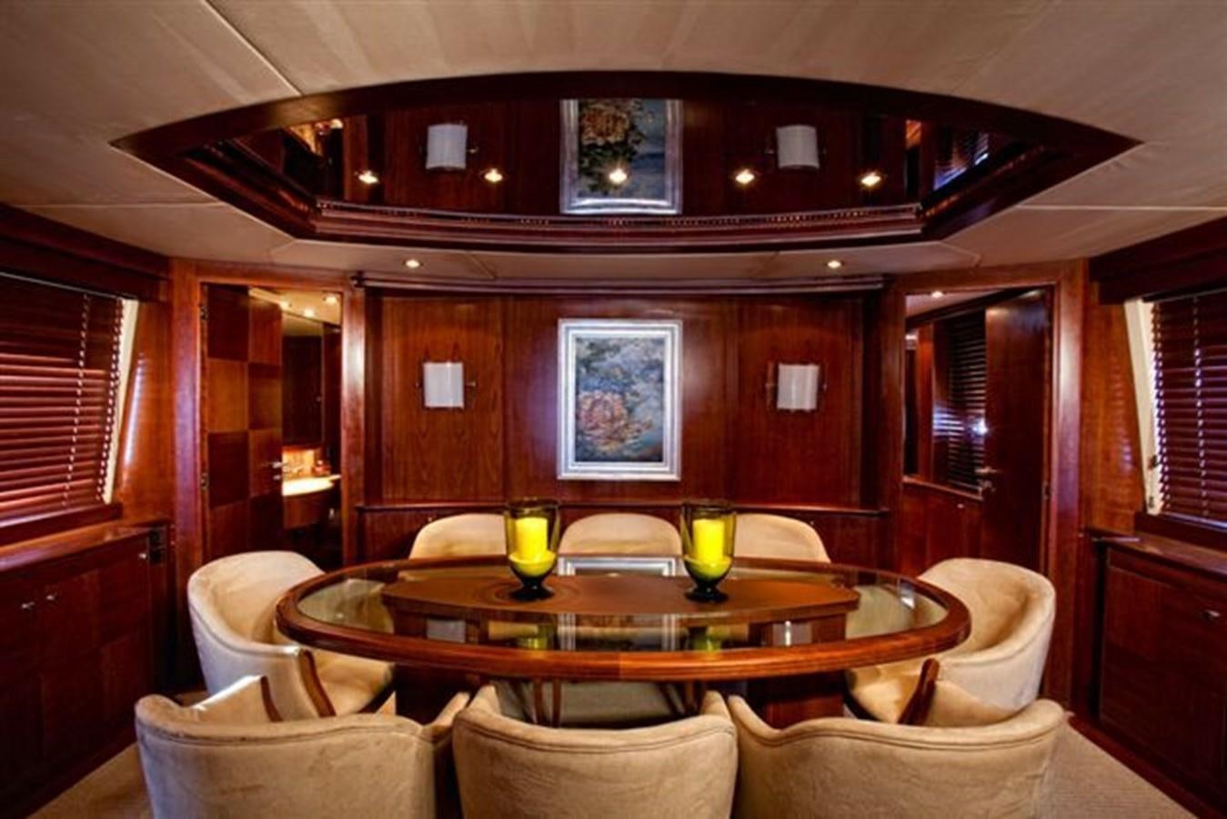 a room with a table and chairs aboard DANIELA Yacht for Sale