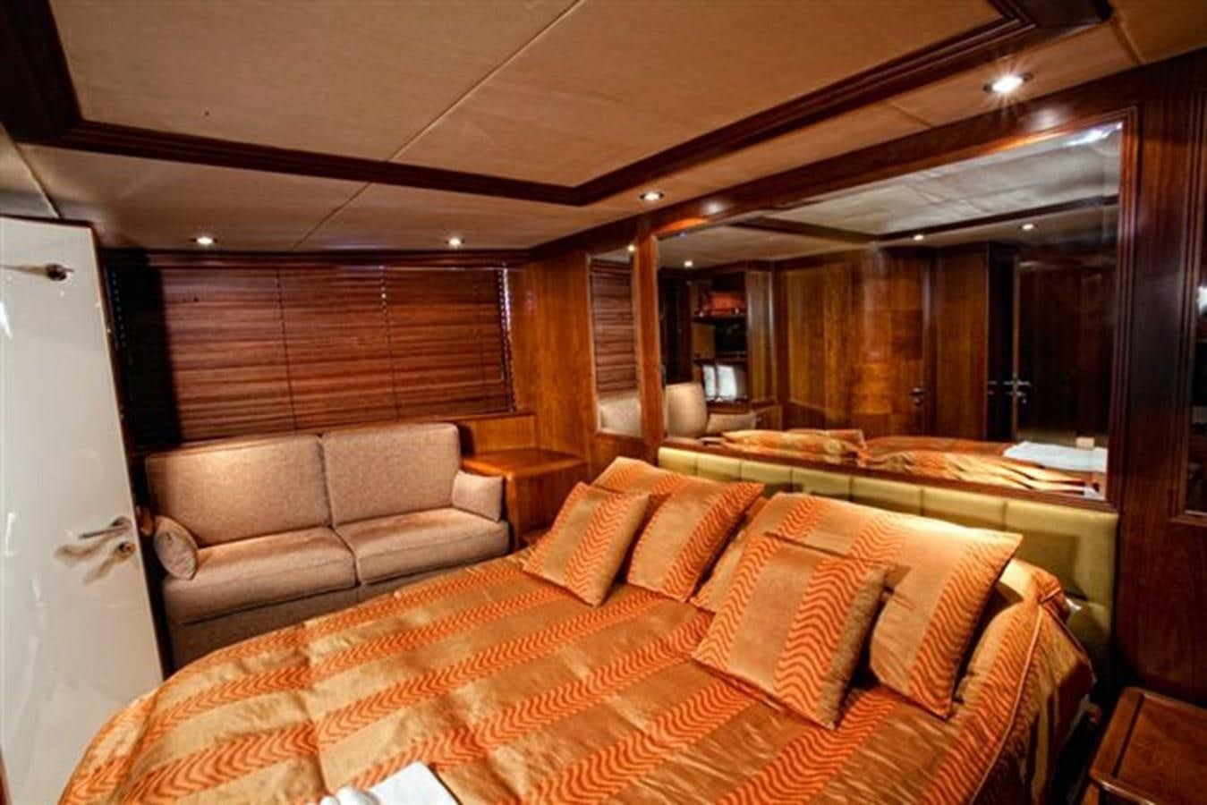 a living room with a couch and a large mirror aboard DANIELA Yacht for Sale