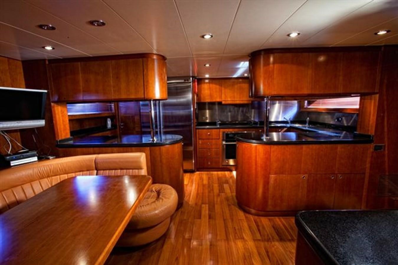 a kitchen with wooden cabinets aboard DANIELA Yacht for Sale