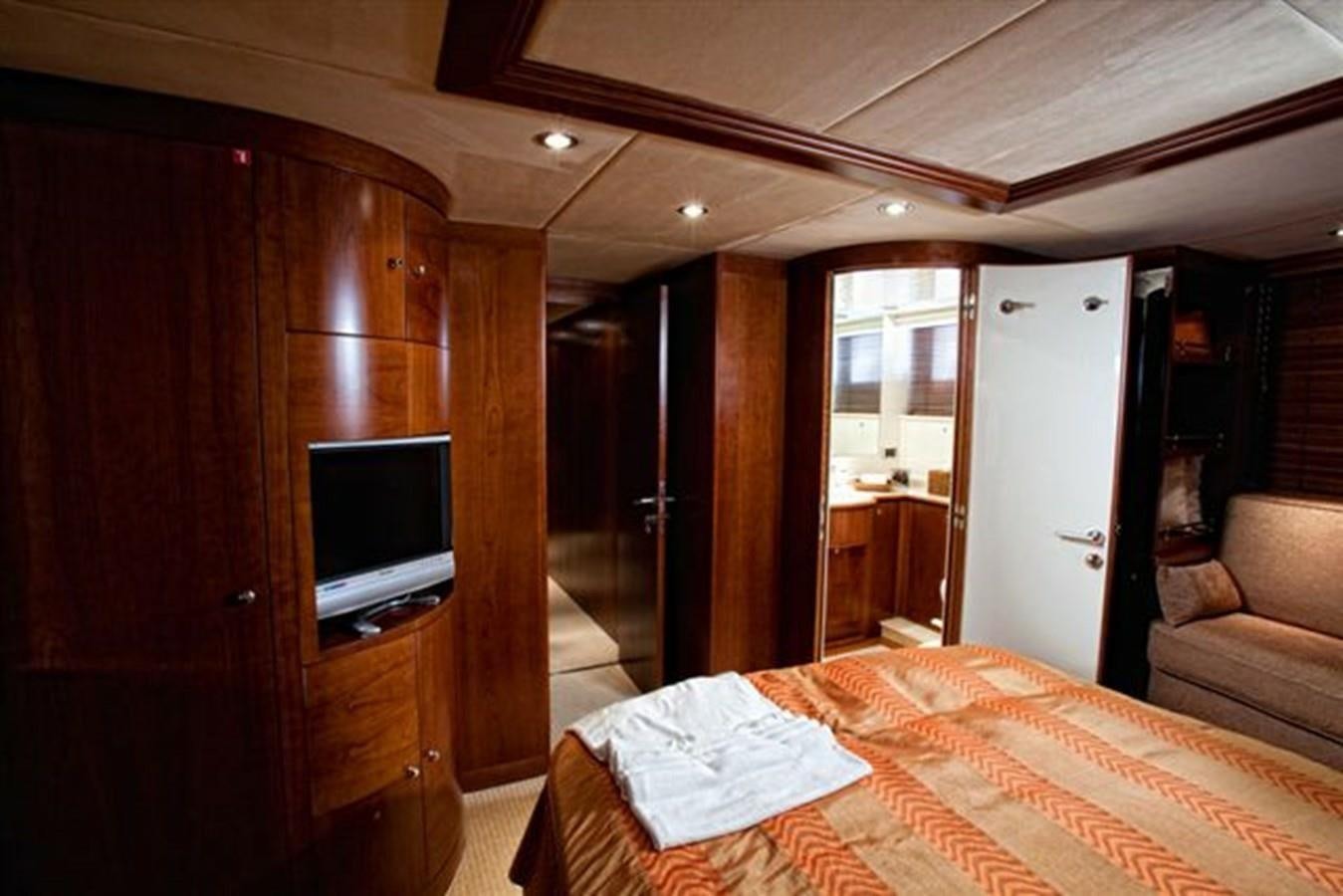a bedroom with a bed and a tv aboard DANIELA Yacht for Sale