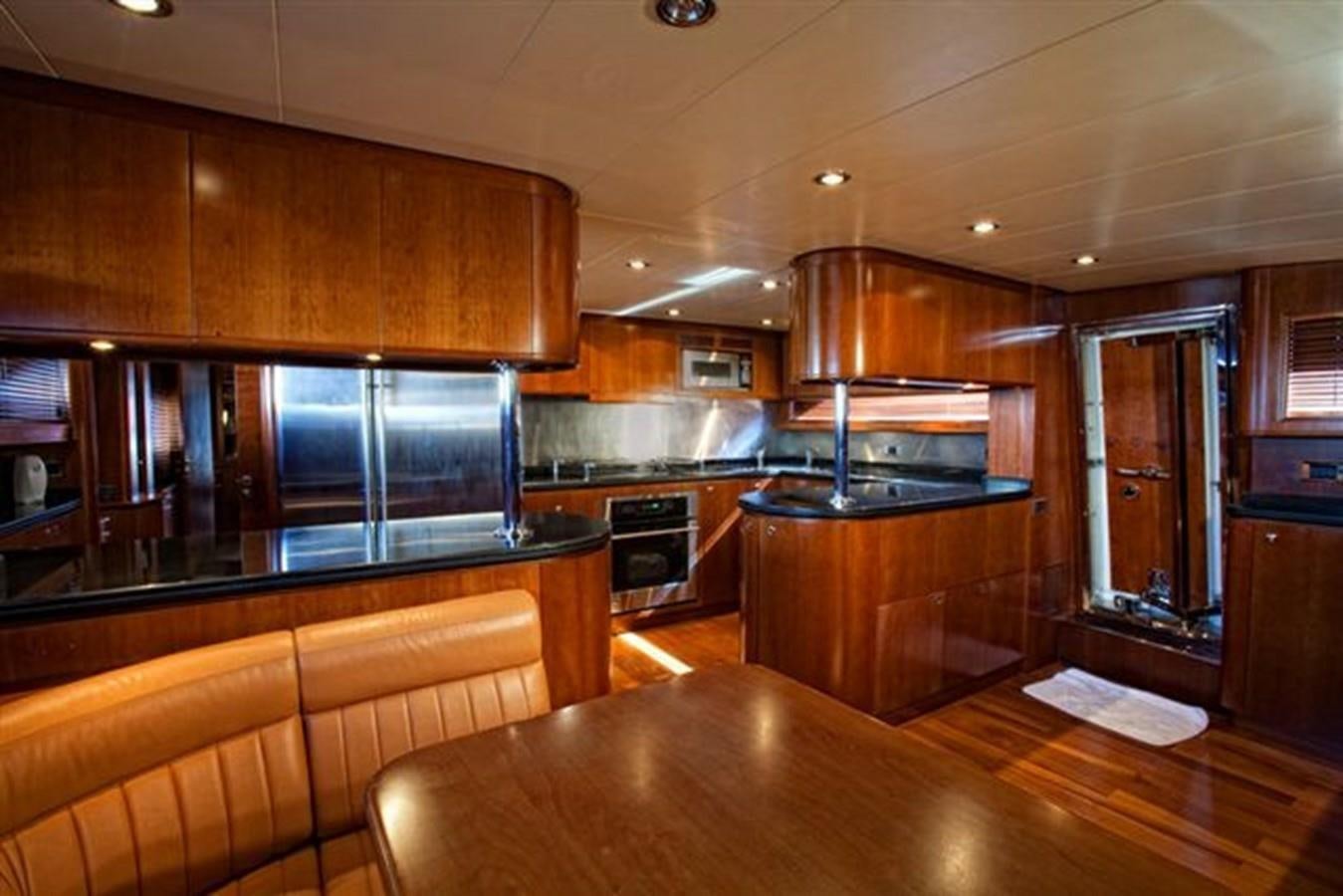 a kitchen with wooden cabinets aboard DANIELA Yacht for Sale