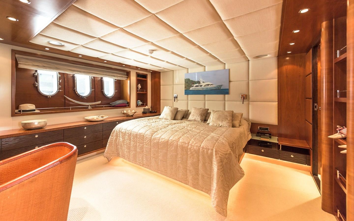 a bedroom with a bed and desk aboard LITTLE PERLE Yacht for Sale