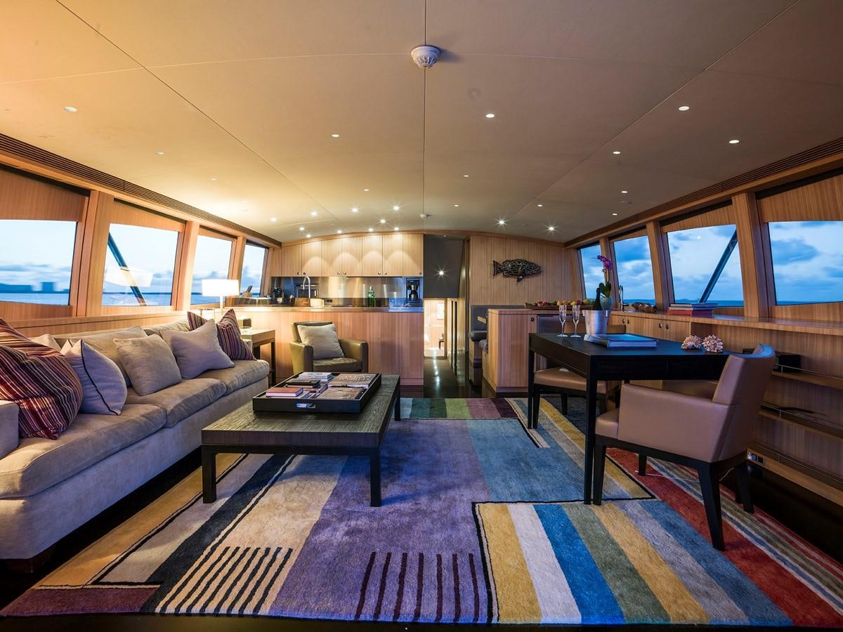 a living room with a couch and a table aboard SATU Yacht for Sale