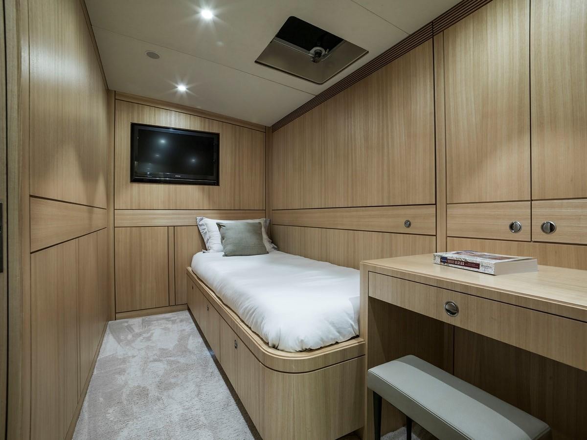 a room with a bed and a television aboard SATU Yacht for Sale