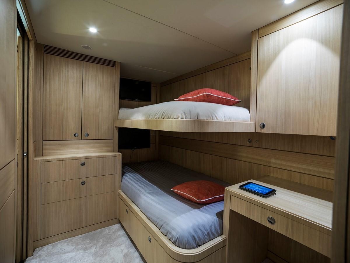a room with a bed and a desk aboard SATU Yacht for Sale