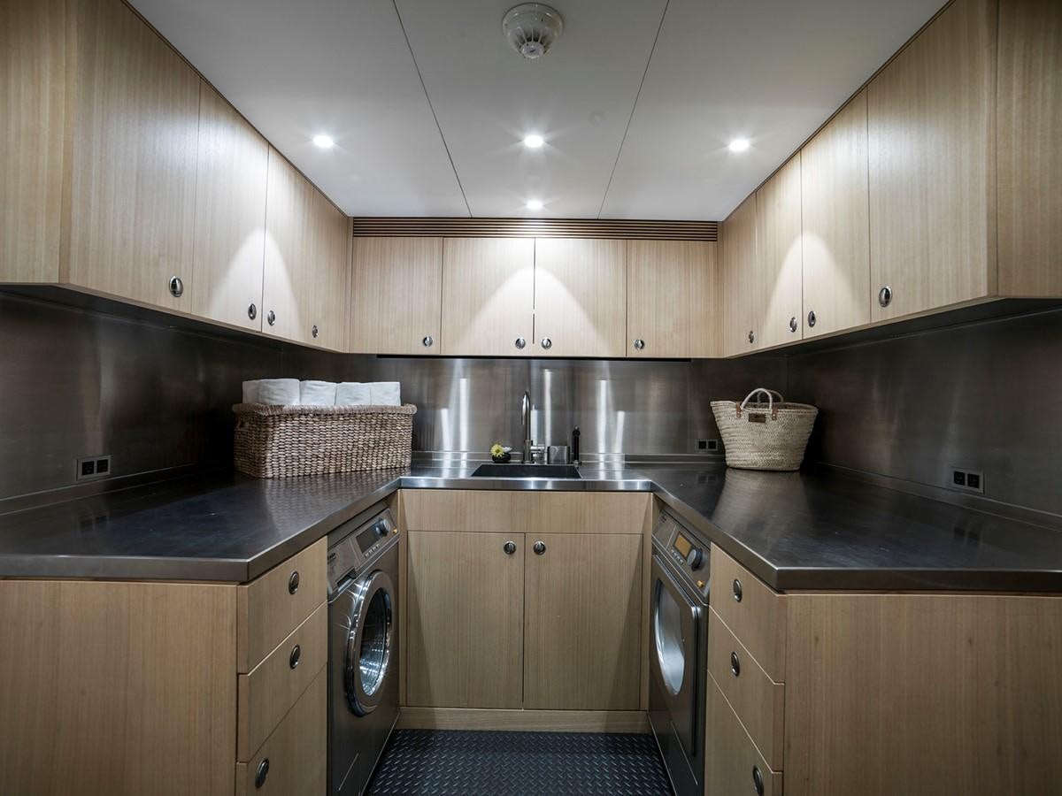 a kitchen with wooden cabinets aboard SATU Yacht for Sale