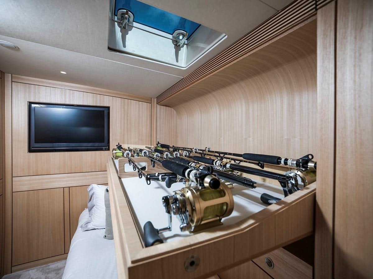 a room with a television and a bed aboard SATU Yacht for Sale