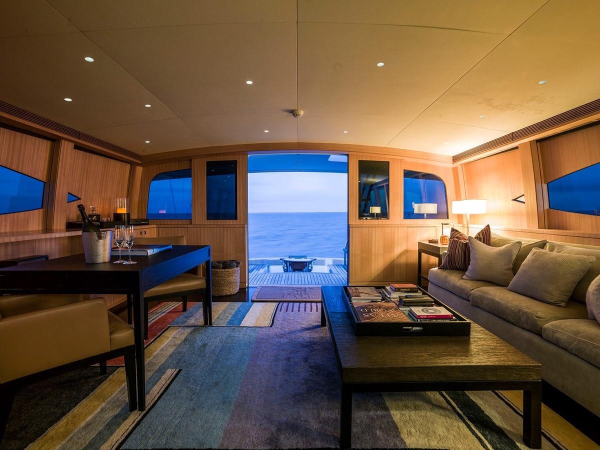 a living room with a large glass door aboard SATU Yacht for Sale