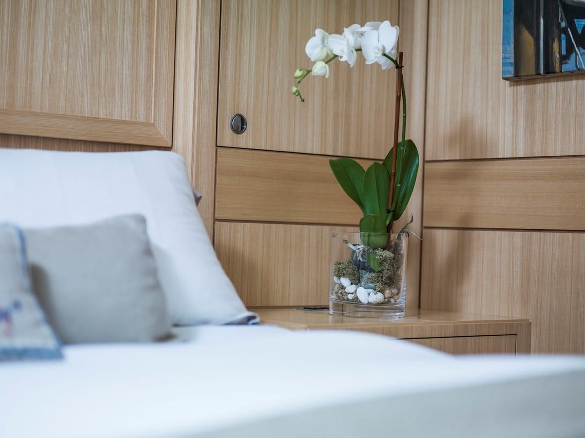 a vase with white flowers in it aboard SATU Yacht for Sale