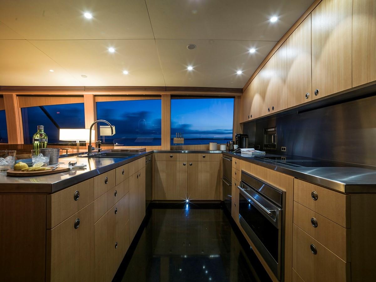 a kitchen with a large window aboard SATU Yacht for Sale