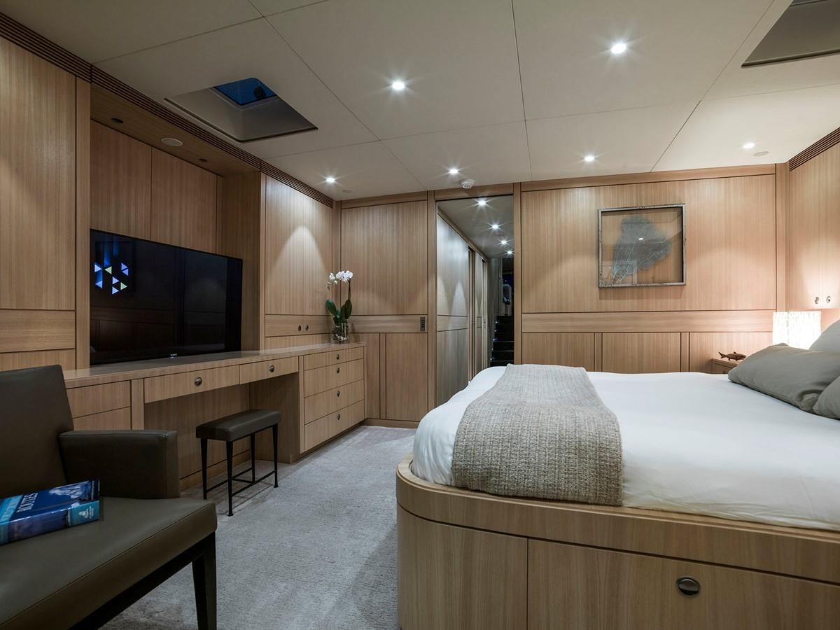 a bedroom with a bed and a tv aboard SATU Yacht for Sale
