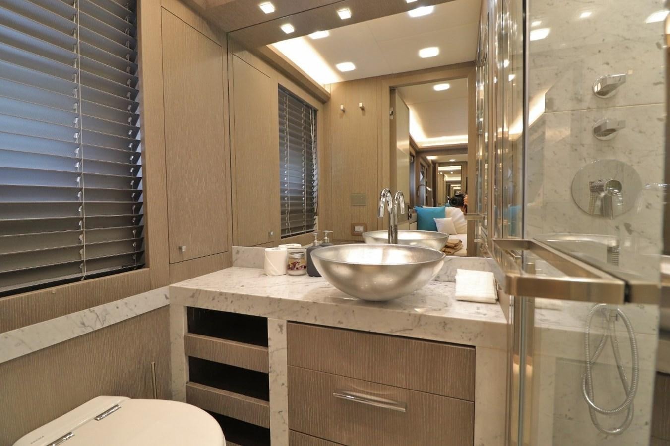 a bathroom with a sink and a mirror aboard MONTE CARLO YACHTS 86 Yacht for Sale