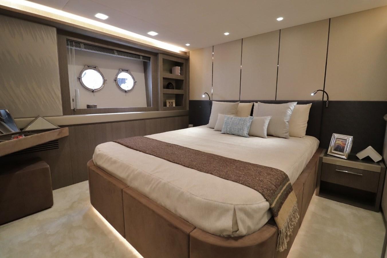 a room with a bed and a desk aboard MONTE CARLO YACHTS 86 Yacht for Sale